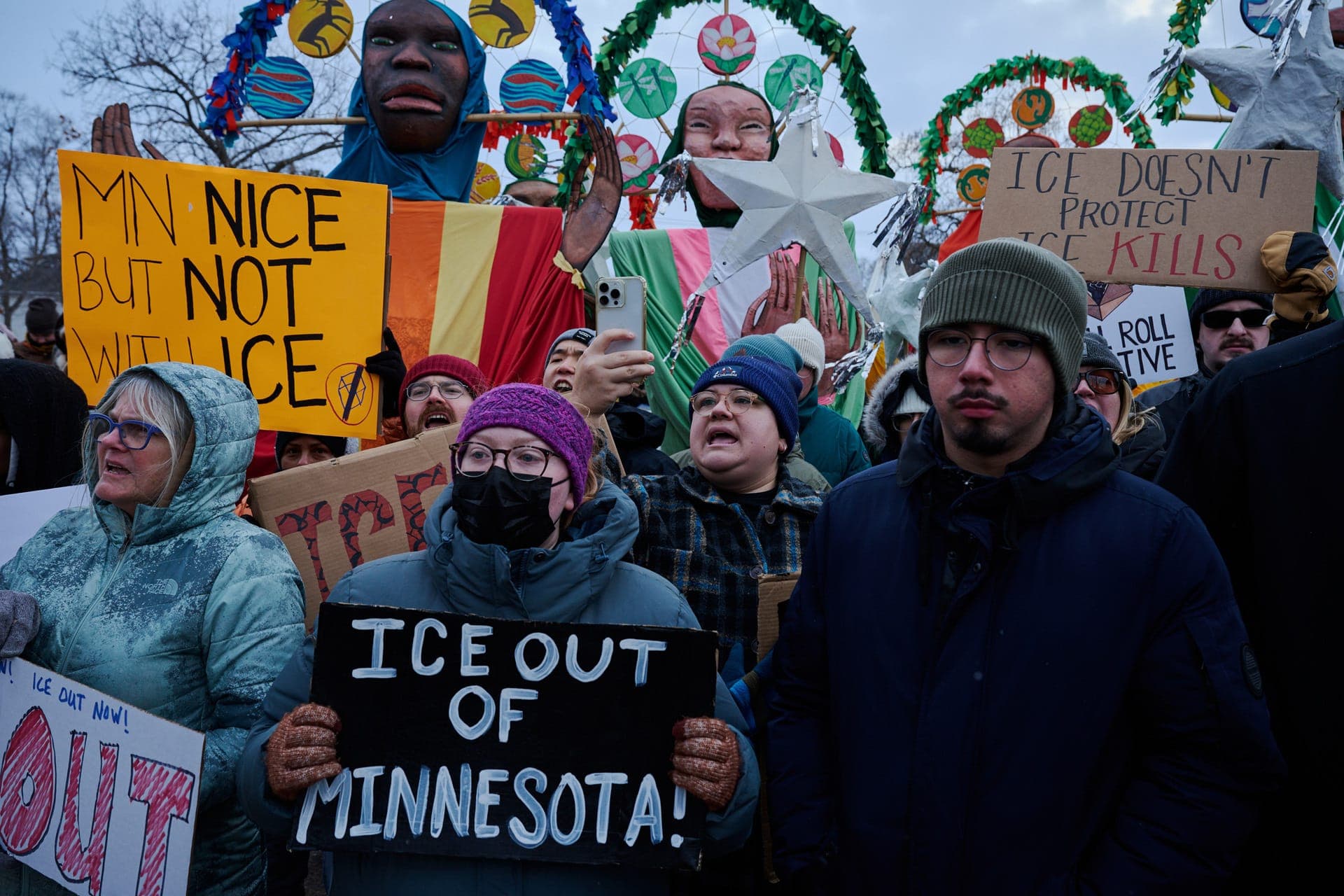 Minnesota rally with signs reading 'ICE out of Minnesota' and 'MN nice but not with ICE.'
